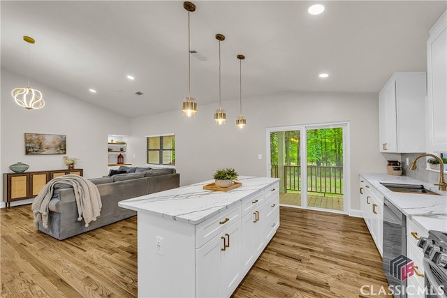 3920 Old Lexington Rd, Athens, GA 30605 - kitchen featuring vaulted ceiling, a sink, light wood-style floors, stainless steel appliances, and a kitchen island