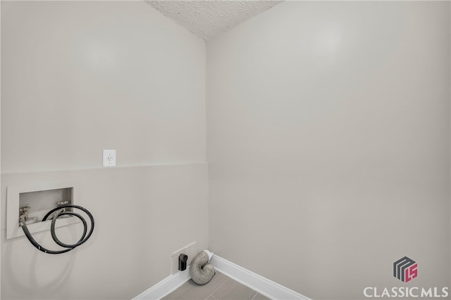 3920 Old Lexington Rd, Athens, GA 30605 - laundry room with baseboards, washer hookup, and a textured ceiling