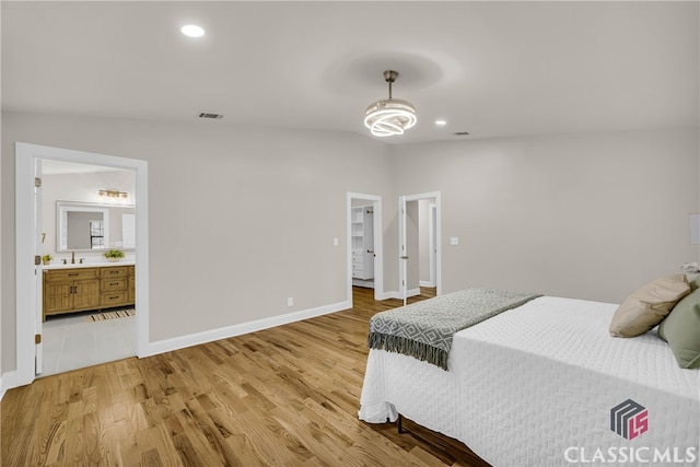 3920 Old Lexington Rd, Athens, GA 30605 - bedroom with light wood-type flooring, baseboards, recessed lighting, ensuite bathroom, and a spacious closet