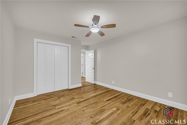 3920 Old Lexington Rd, Athens, GA 30605 - unfurnished bedroom featuring baseboards, light wood-style flooring, a closet, and a ceiling fan
