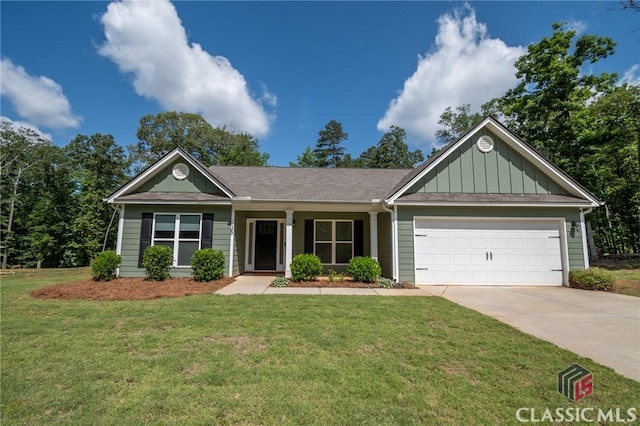 35 Westwood St, Danielsville, GA 30633 - view of front of home featuring board and batten siding, concrete driveway, an attached garage, and a front yard