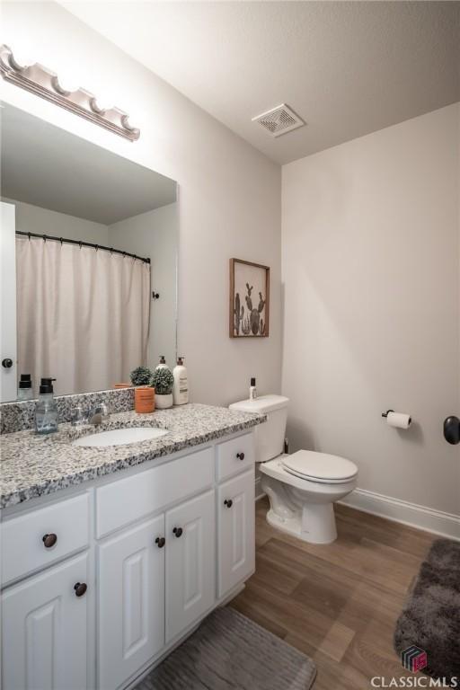 35 Westwood St, Danielsville, GA 30633 - full bathroom with toilet, vanity, wood finished floors, and baseboards