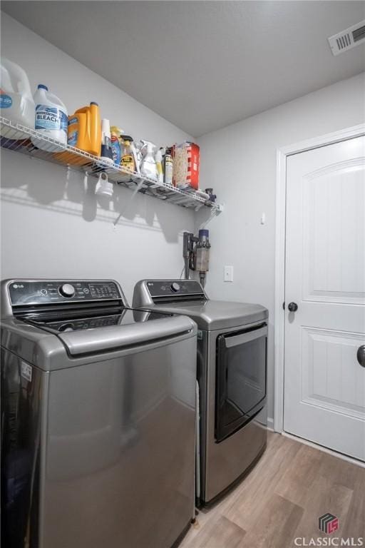 35 Westwood St, Danielsville, GA 30633 - laundry area featuring washing machine and dryer and light wood-style floors