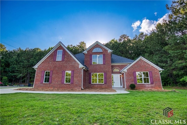 4085 Fawn Vly, Loganville, GA 30052 - traditional-style house with a front lawn and brick siding