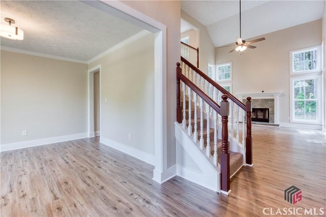 4085 Fawn Vly, Loganville, GA 30052 - stairs with healthy amount of natural light, wood finished floors, ceiling fan, baseboards, and ornamental molding