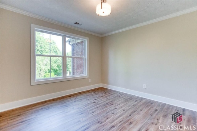 4085 Fawn Vly, Loganville, GA 30052 - unfurnished room with wood finished floors, crown molding, and baseboards