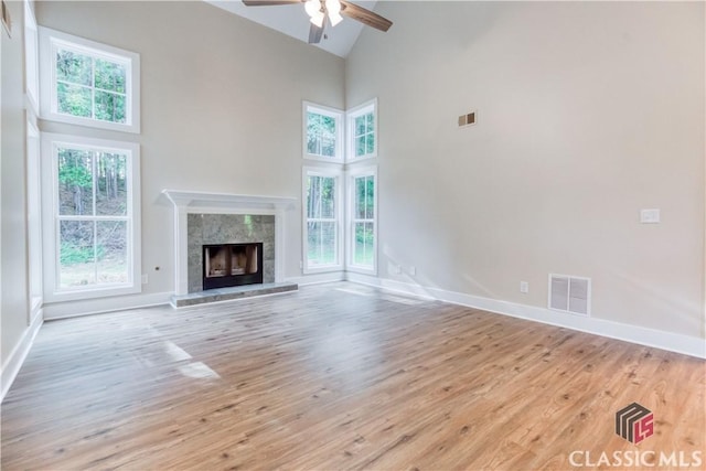 4085 Fawn Vly, Loganville, GA 30052 - unfurnished living room with high vaulted ceiling, light wood-type flooring, a ceiling fan, healthy amount of natural light, and baseboards