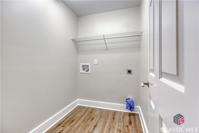 4085 Fawn Vly, Loganville, GA 30052 - washroom with hookup for a washing machine, wood finished floors, baseboards, and hookup for an electric dryer