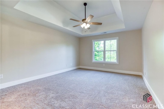 4085 Fawn Vly, Loganville, GA 30052 - carpeted empty room with a tray ceiling, ceiling fan, and baseboards