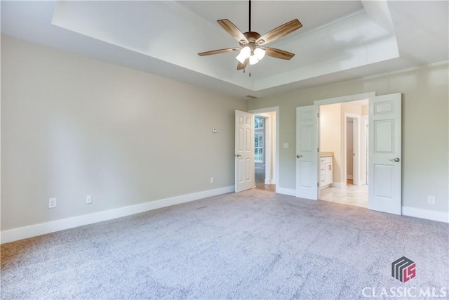 4085 Fawn Vly, Loganville, GA 30052 - unfurnished bedroom with a raised ceiling, light carpet, baseboards, and ceiling fan