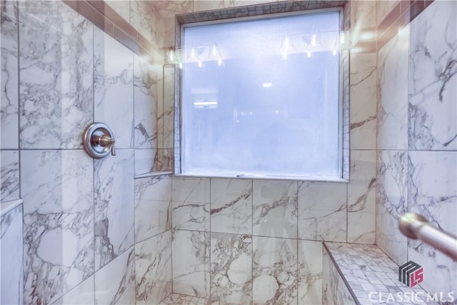 4085 Fawn Vly, Loganville, GA 30052 - bathroom featuring a tile shower and healthy amount of natural light