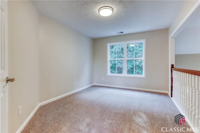 4085 Fawn Vly, Loganville, GA 30052 - carpeted spare room with baseboards and a textured ceiling