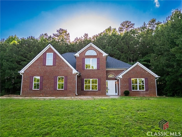 4085 Fawn Vly, Loganville, GA 30052 - traditional-style home featuring a front lawn and brick siding