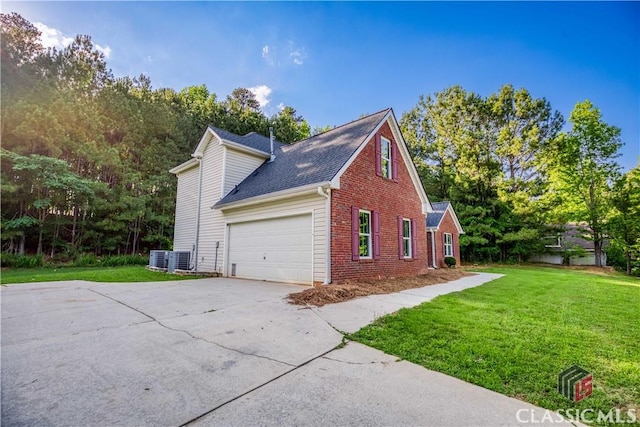 4085 Fawn Vly, Loganville, GA 30052 - view of property exterior with brick siding, driveway, a garage, and a yard