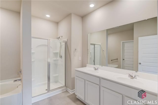 334 Pepin Ct, Hoschton, GA 30548 - bathroom featuring a shower stall, a bath, double vanity, and recessed lighting