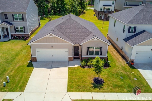 334 Pepin Ct, Hoschton, GA 30548 - view of front of home with board and batten siding, concrete driveway, an attached garage, and a front yard