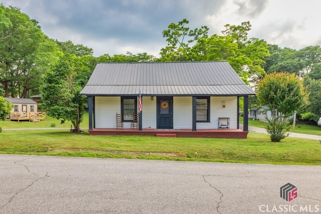 99 Hickory St, Commerce, GA 30529 - view of front of property with a front lawn, a porch, and metal roof