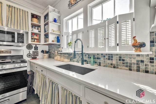 99 Hickory St, Commerce, GA 30529 - kitchen with appliances with stainless steel finishes, a sink, decorative backsplash, open shelves, and white cabinets