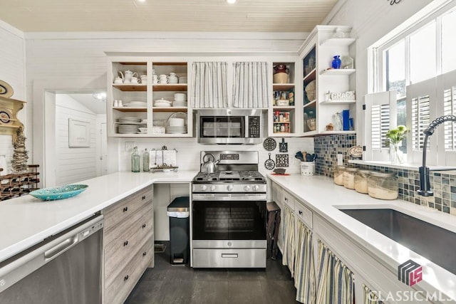 99 Hickory St, Commerce, GA 30529 - kitchen with stainless steel appliances, a sink, decorative backsplash, light countertops, and dark wood-style floors