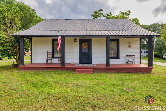 99 Hickory St, Commerce, GA 30529 - country-style home featuring covered porch, a front yard, and metal roof