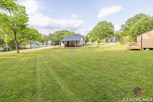 99 Hickory St, Commerce, GA 30529 - view of grassy yard with a wooden deck
