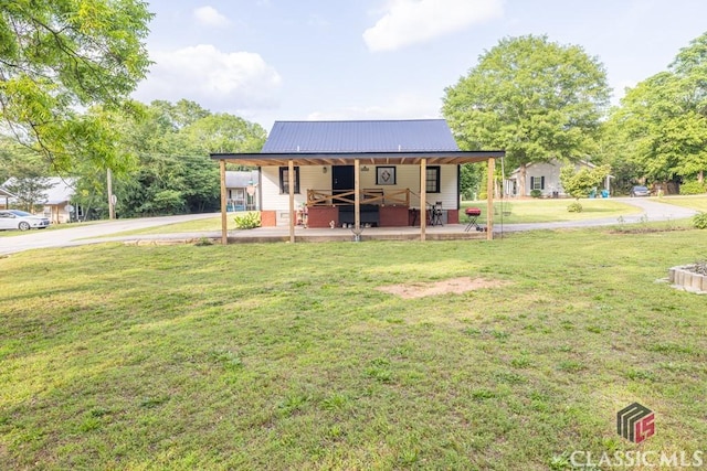 99 Hickory St, Commerce, GA 30529 - view of front facade with driveway, a front yard, and metal roof
