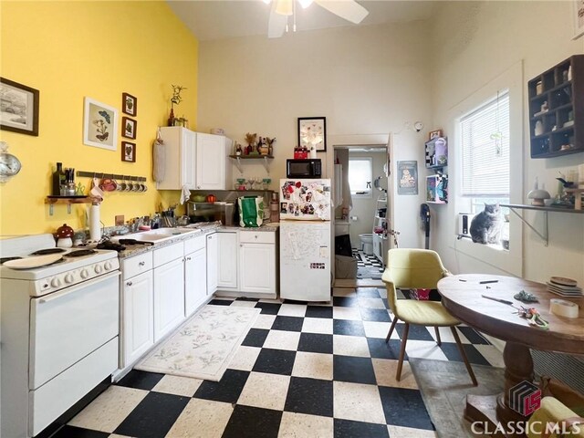 485 Meigs St, Athens, GA 30601 - kitchen with white appliances, tile patterned floors, white cabinets, a ceiling fan, and a high ceiling