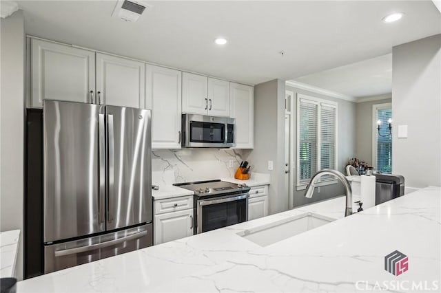 1050 Tailwater Unit A, Greensboro, GA 30642 - kitchen featuring appliances with stainless steel finishes, a sink, decorative backsplash, recessed lighting, and light stone counters