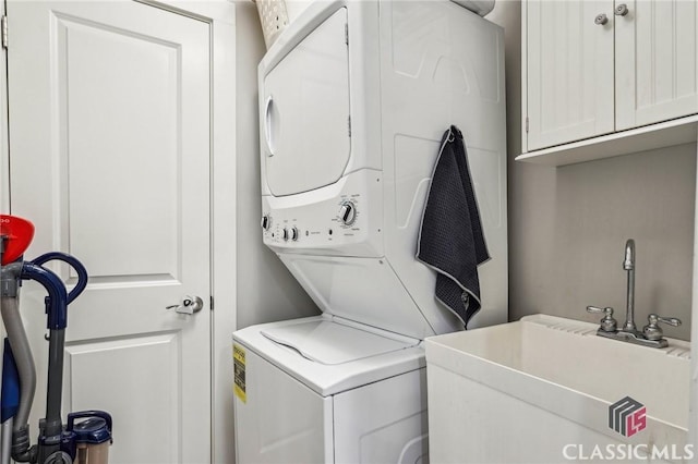 1050 Tailwater Unit A, Greensboro, GA 30642 - laundry room featuring stacked washer / dryer and cabinet space
