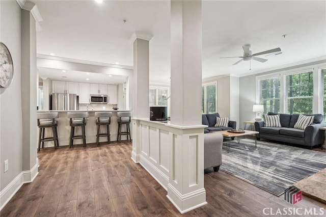 1050 Tailwater Unit A, Greensboro, GA 30642 - living room featuring crown molding, dark wood finished floors, a ceiling fan, and baseboards