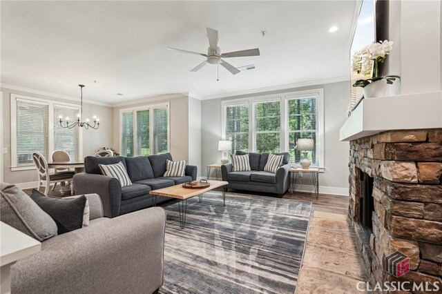 1050 Tailwater Unit A, Greensboro, GA 30642 - living area with a chandelier, ornamental molding, a fireplace, ceiling fan, and baseboards