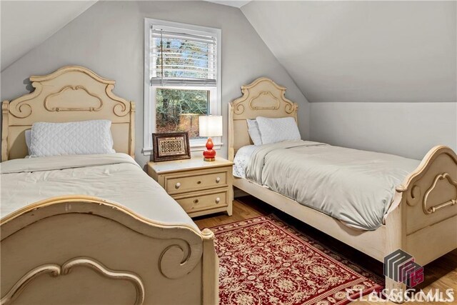 1061 Calls Creek Dr, Watkinsville, GA 30677 - bedroom with vaulted ceiling and light wood-type flooring