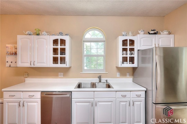 224 Red Oak Dr, Maysville, GA 30558 - kitchen featuring stainless steel appliances, a sink, white cabinets, glass insert cabinets, and light countertops