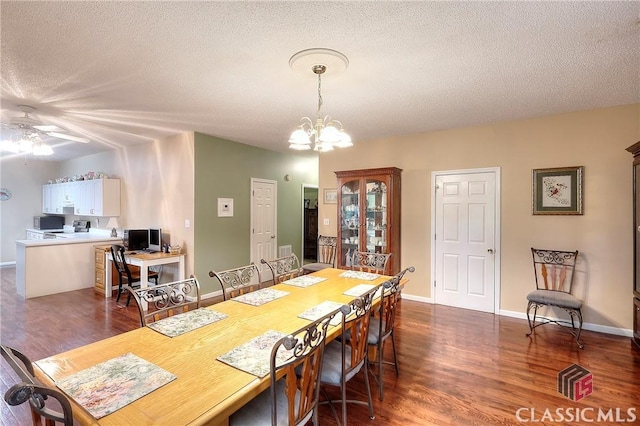224 Red Oak Dr, Maysville, GA 30558 - dining room featuring dark wood-style floors, a ceiling fan, a textured ceiling, a desk, and a chandelier