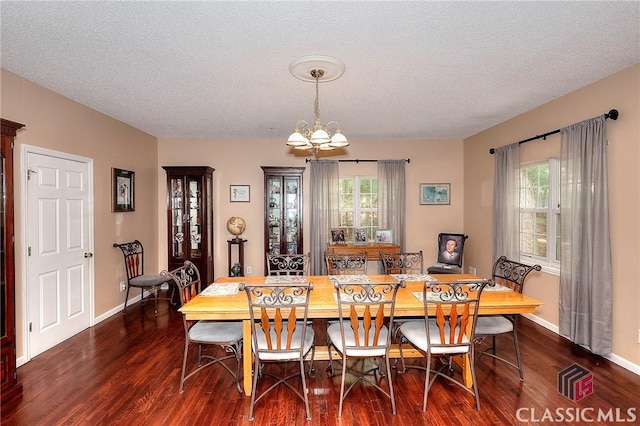224 Red Oak Dr, Maysville, GA 30558 - dining area featuring a chandelier, wood finished floors, a textured ceiling, and baseboards
