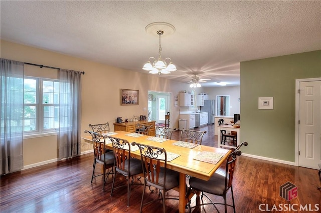 224 Red Oak Dr, Maysville, GA 30558 - dining area with dark wood finished floors, a ceiling fan, baseboards, a chandelier, and a textured ceiling