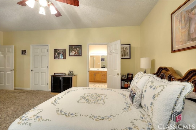 224 Red Oak Dr, Maysville, GA 30558 - carpeted bedroom featuring connected bathroom, a textured ceiling, ceiling fan, and baseboards
