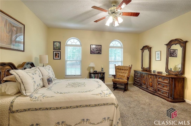 224 Red Oak Dr, Maysville, GA 30558 - carpeted bedroom featuring a textured ceiling, ceiling fan, and baseboards