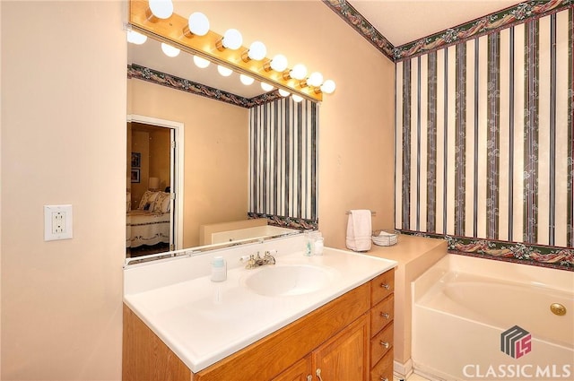 224 Red Oak Dr, Maysville, GA 30558 - full bath with a garden tub, ensuite bathroom, vanity, and wallpapered walls