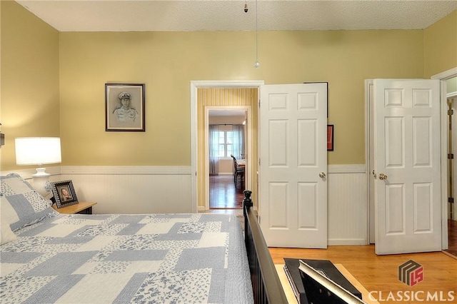 224 Red Oak Dr, Maysville, GA 30558 - bedroom with light wood finished floors and wainscoting