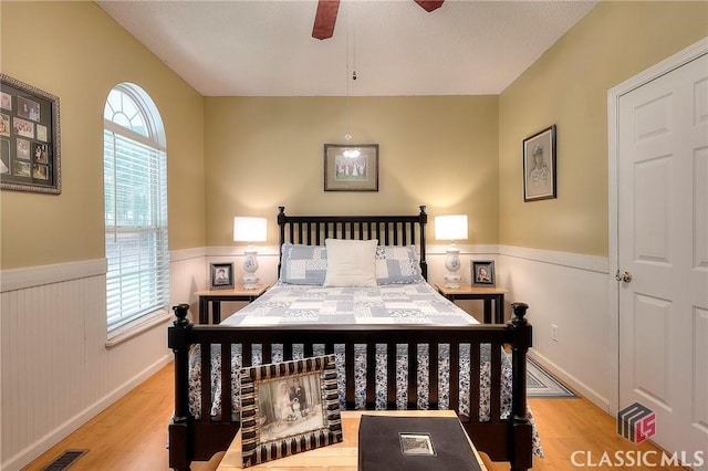 224 Red Oak Dr, Maysville, GA 30558 - bedroom with a wainscoted wall, wood finished floors, and a ceiling fan