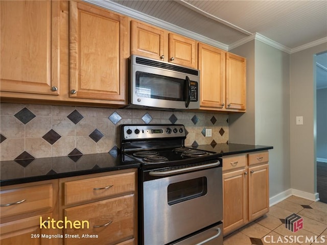 269 Magnolia St, Athens, GA 30606 - kitchen with stainless steel appliances, dark countertops, backsplash, ornamental molding, and light tile patterned flooring