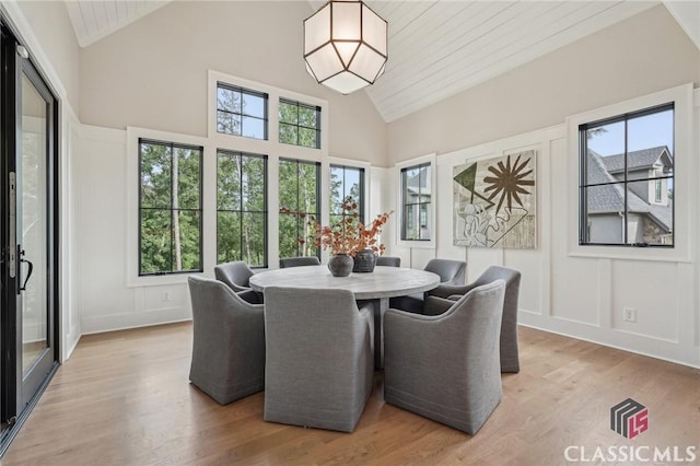 1170 Broadpoint Dr, Greensboro, GA 30642 - dining room with light wood finished floors, high vaulted ceiling, a decorative wall, and wooden ceiling
