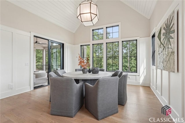 1170 Broadpoint Dr, Greensboro, GA 30642 - dining space featuring high vaulted ceiling and light wood-style flooring