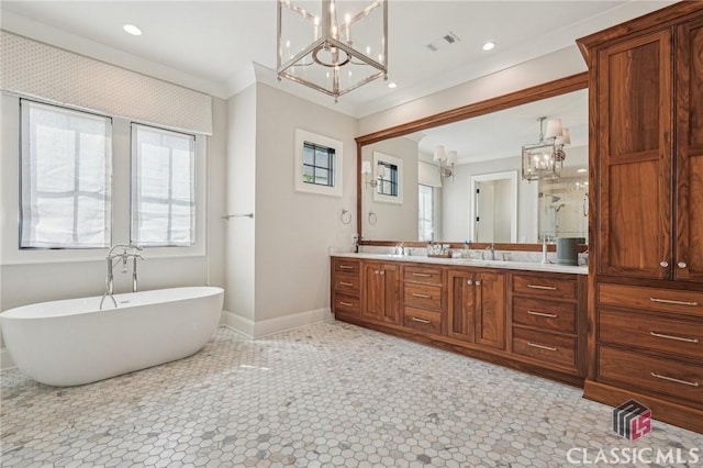 1170 Broadpoint Dr, Greensboro, GA 30642 - full bathroom with a chandelier, double vanity, a soaking tub, baseboards, and recessed lighting