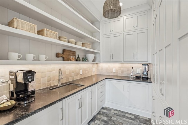 1170 Broadpoint Dr, Greensboro, GA 30642 - kitchen with open shelves, a sink, decorative backsplash, white cabinetry, and dark stone countertops