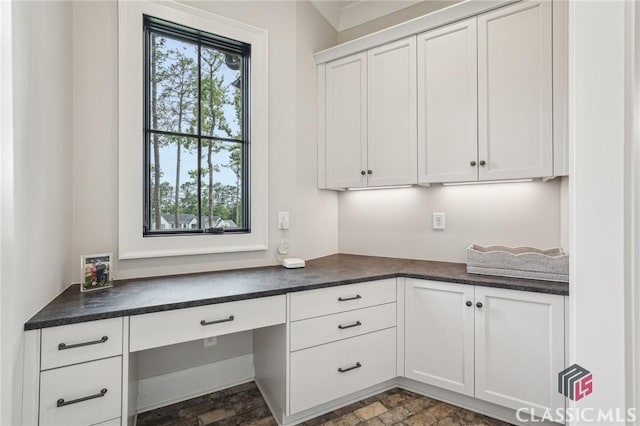 1170 Broadpoint Dr, Greensboro, GA 30642 - unfurnished office featuring built in desk and stone finish flooring