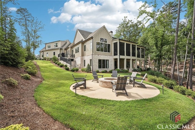 1170 Broadpoint Dr, Greensboro, GA 30642 - rear view of property featuring an outdoor fire pit, a patio, a yard, a sunroom, and brick siding