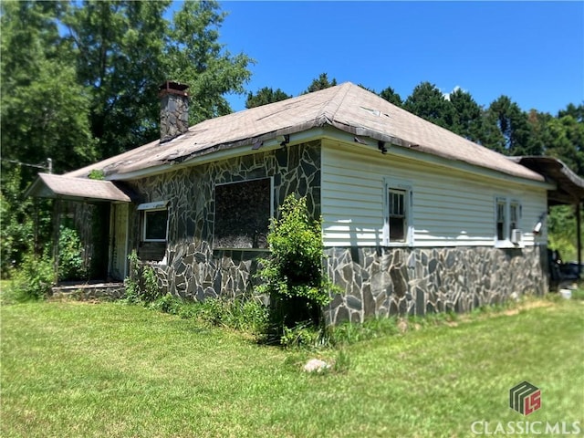 72 N Pomona Rd, Hampton, GA 30228 - view of side of home with a lawn, a chimney, and stone siding
