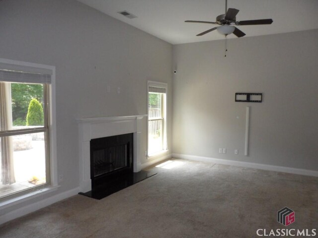 628 Holliman Cir, Pendergrass, GA 30567 - unfurnished living room with carpet, plenty of natural light, and a fireplace with raised hearth